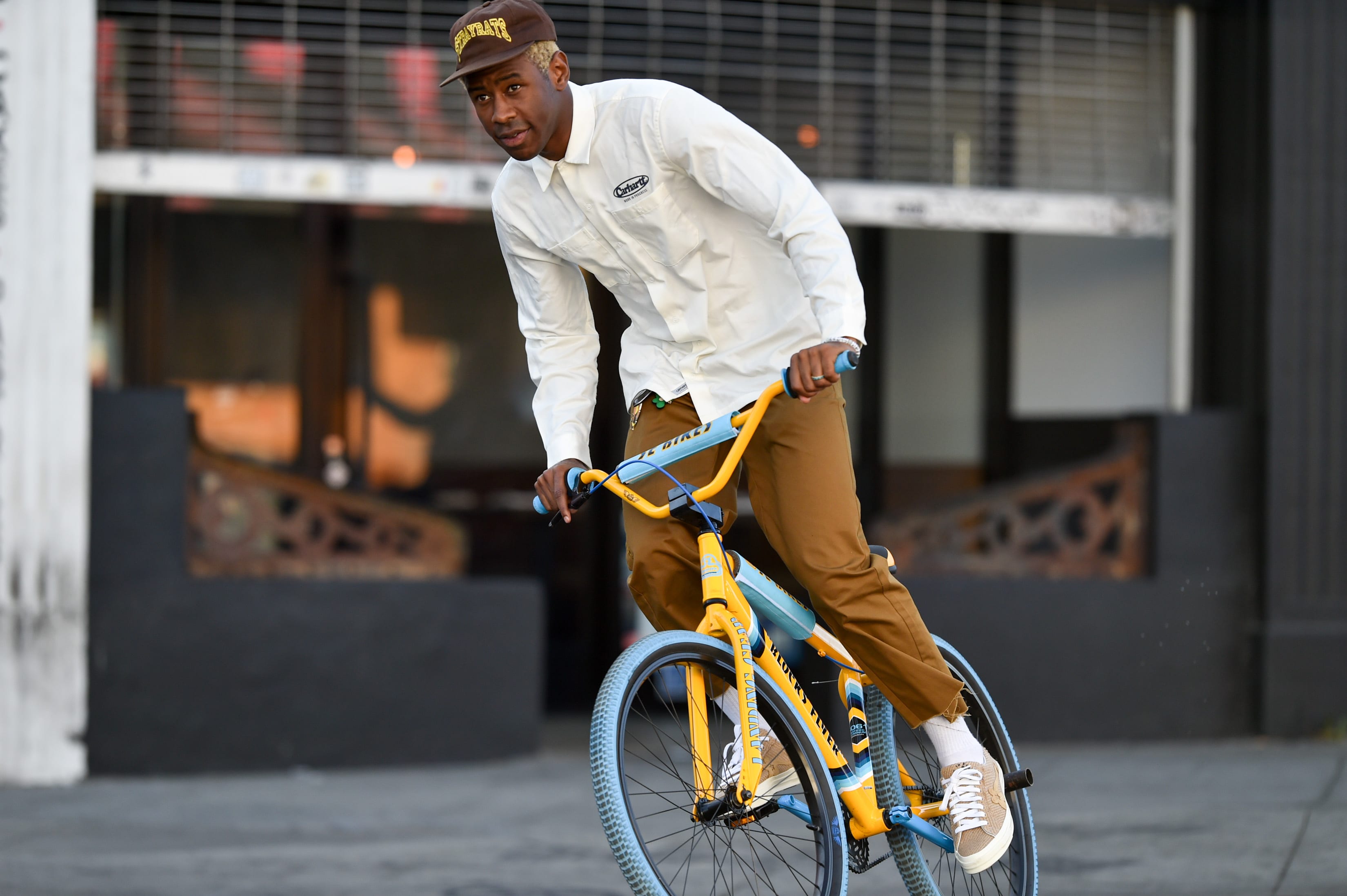 Tyler the Creator at the Grammys wearing Supreme Wool Overcoat, Louis  Vuitton Scarf & Converse Chuck Taylor All Star